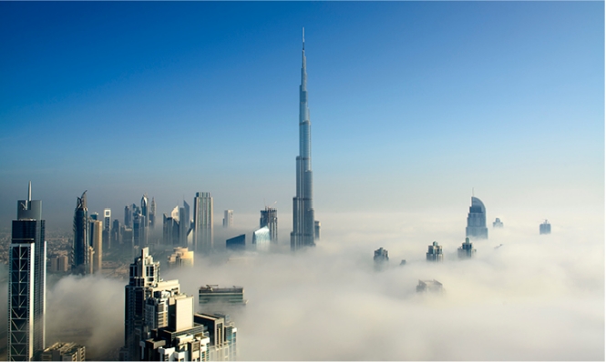 Dubai skyline with the Burj Khalifa towering through layer of clouds